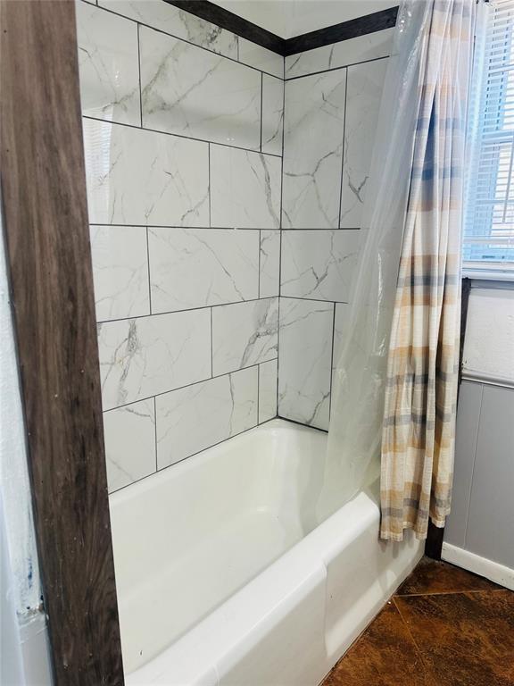 full bathroom with shower / bath combo with shower curtain