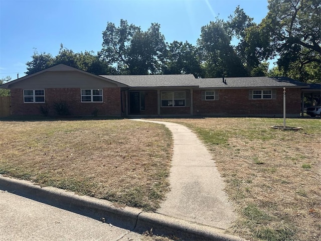 ranch-style home with brick siding and a front yard
