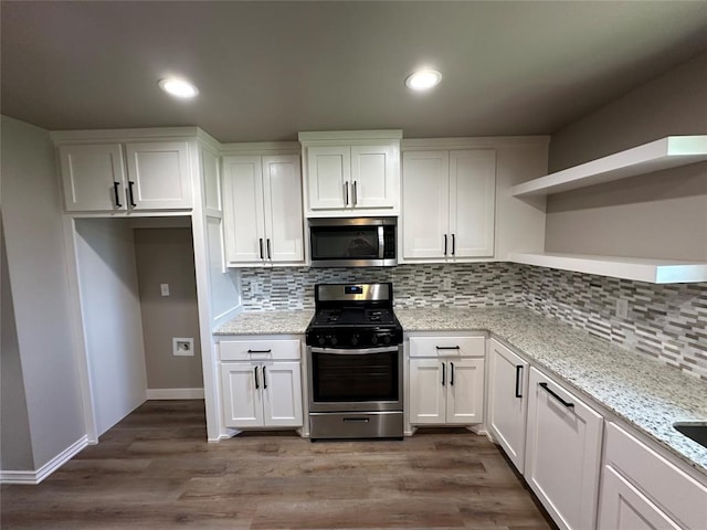 kitchen featuring open shelves, appliances with stainless steel finishes, tasteful backsplash, and white cabinetry