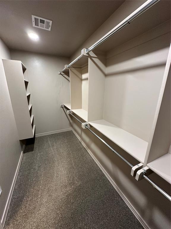 walk in closet with carpet floors and visible vents