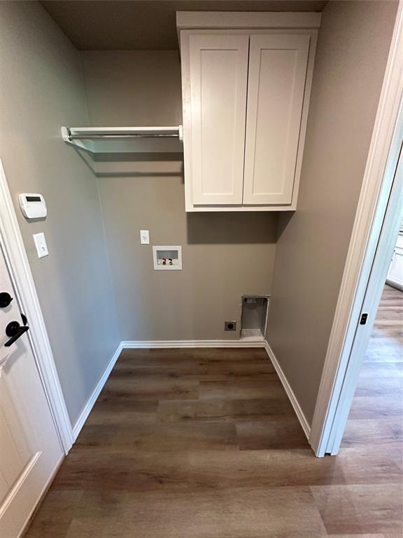laundry area featuring baseboards, electric dryer hookup, washer hookup, and wood finished floors