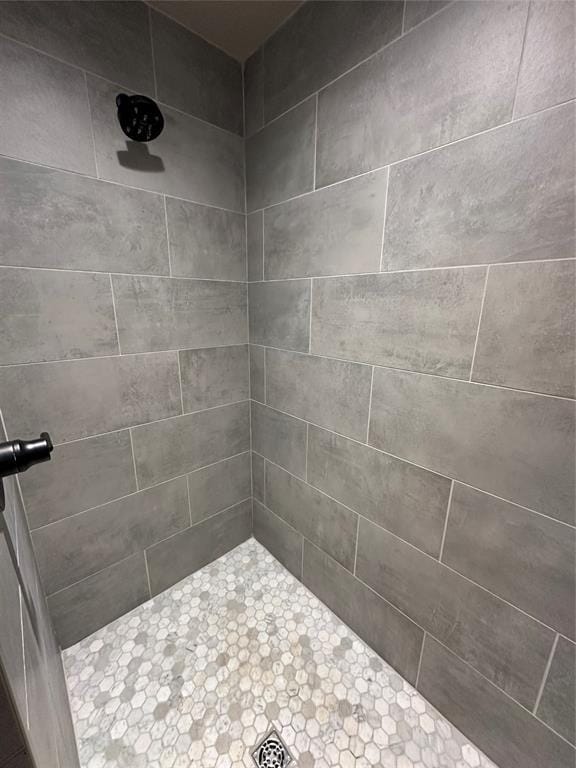 full bath with a tile shower