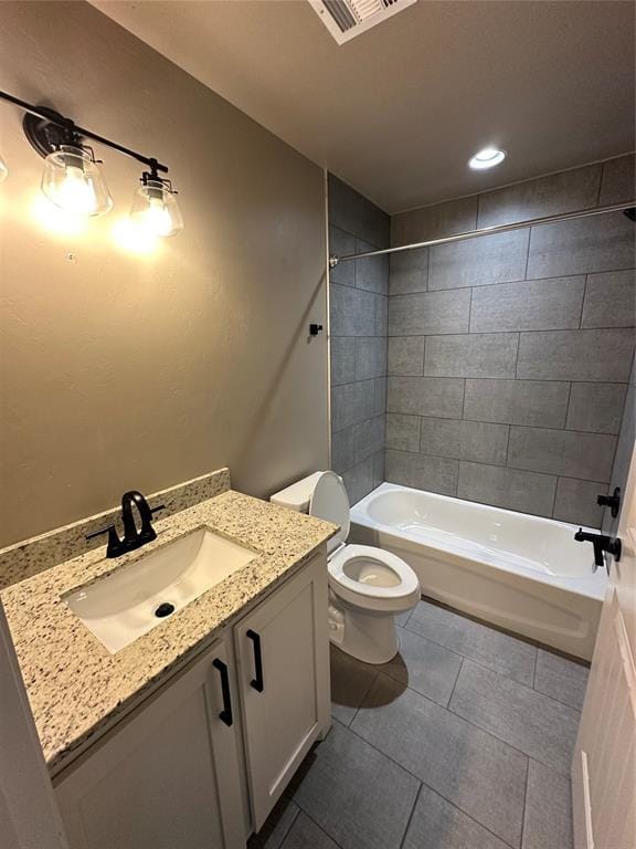 bathroom with toilet, visible vents, tile patterned floors, vanity, and shower / bathing tub combination