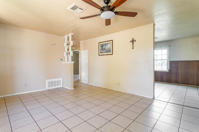 410 W 4th St, Hennessey, OK 73742 - spare room with light tile patterned floors, a wainscoted wall, visible vents, and ceiling fan