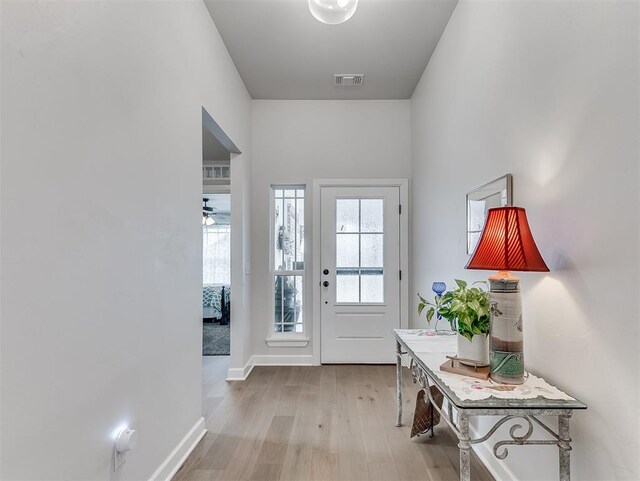 15936 Buffalo Dr, Oklahoma City, OK 73170 - doorway featuring a ceiling fan, visible vents, wood finished floors, and baseboards