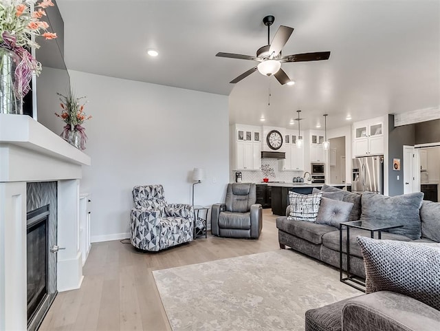 15936 Buffalo Dr, Oklahoma City, OK 73170 - living area with light wood-style flooring, ceiling fan, baseboards, recessed lighting, and a premium fireplace