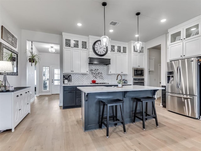 15936 Buffalo Dr, Oklahoma City, OK 73170 - kitchen featuring tasteful backsplash, visible vents, light wood-style floors, and appliances with stainless steel finishes