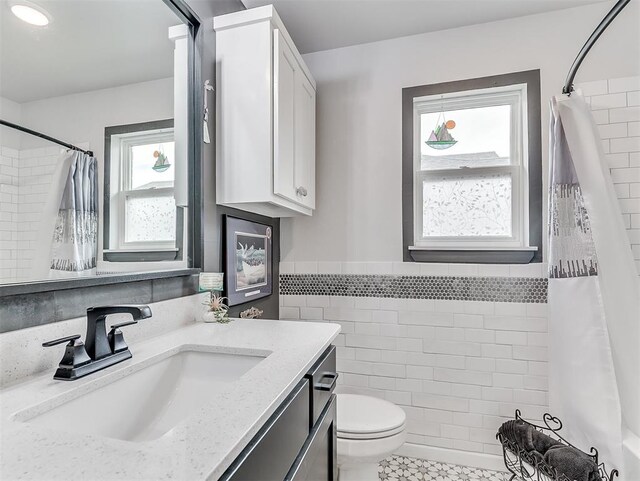 15936 Buffalo Dr, Oklahoma City, OK 73170 - full bath with a healthy amount of sunlight, toilet, curtained shower, and tile walls