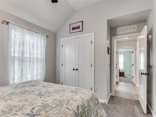 15936 Buffalo Dr, Oklahoma City, OK 73170 - carpeted bedroom featuring a closet, visible vents, vaulted ceiling, and baseboards