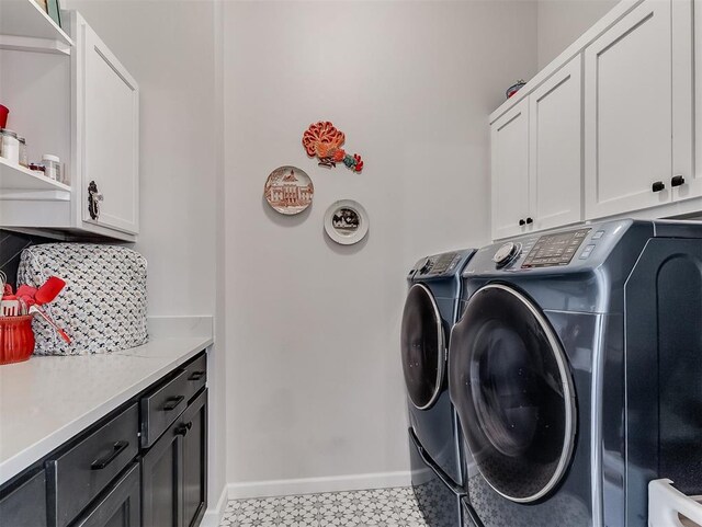 15936 Buffalo Dr, Oklahoma City, OK 73170 - laundry area featuring light floors, washer and clothes dryer, cabinet space, and baseboards