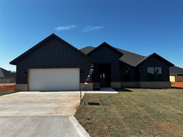 211 Shavano St, Shawnee, OK 74804 - modern farmhouse with board and batten siding, an attached garage, concrete driveway, a shingled roof, and a front lawn
