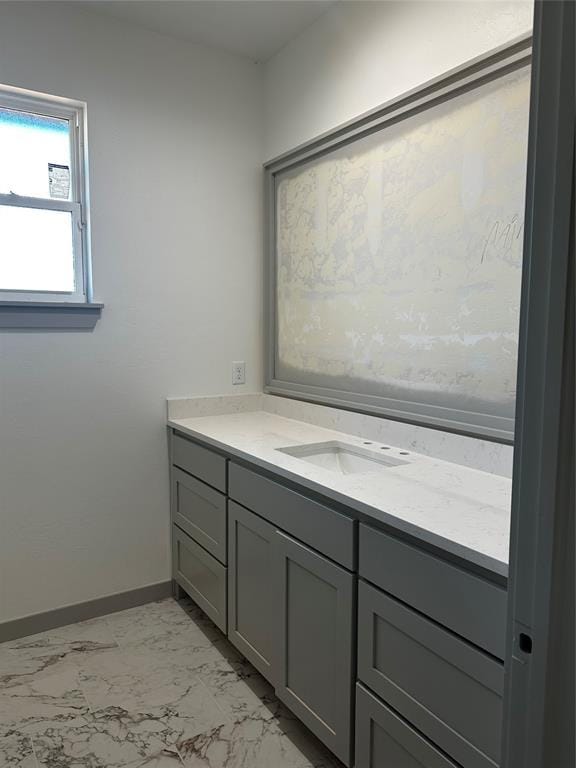 211 Shavano St, Shawnee, OK 74804 - bathroom featuring marble look tiles, baseboards, and vanity