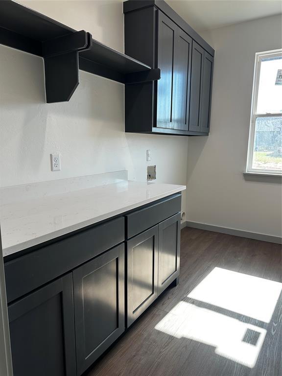 211 Shavano St, Shawnee, OK 74804 - laundry room featuring cabinet space, washer hookup, dark wood-style floors, and baseboards