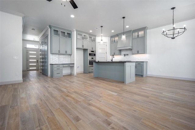 2909 SW 132nd St, Oklahoma City, OK 73170 - kitchen featuring backsplash, recessed lighting, light wood-style floors, and ceiling fan with notable chandelier