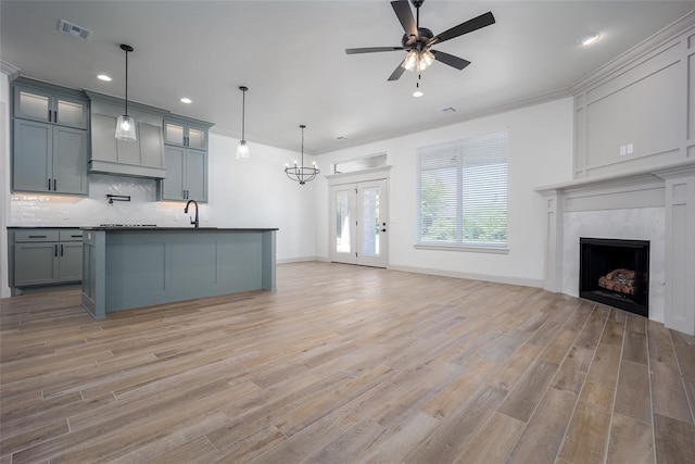 2909 SW 132nd St, Oklahoma City, OK 73170 - kitchen with a sink, light wood-type flooring, open floor plan, visible vents, and ceiling fan with notable chandelier