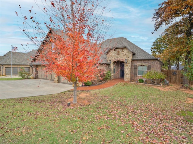 1832 Buckskin Ct, Blanchard, OK 73010 - french country home featuring fence, a front lawn, driveway, and stone siding