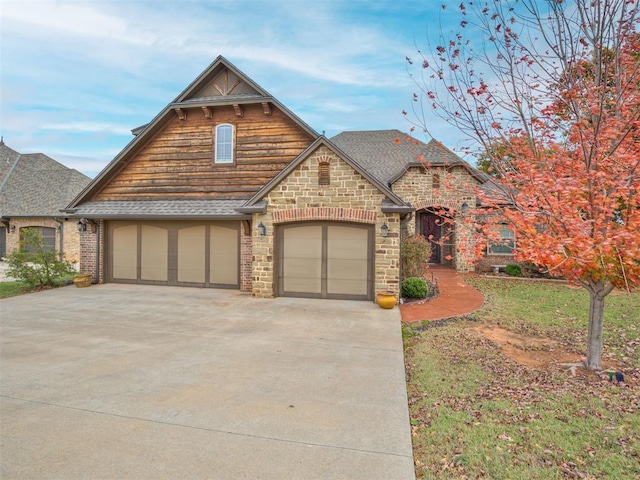1832 Buckskin Ct, Blanchard, OK 73010 - view of front of home with stone siding, roof with shingles, a garage, and concrete driveway