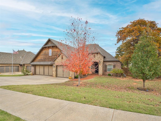 1832 Buckskin Ct, Blanchard, OK 73010 - view of front of home with stone siding, driveway, a front yard, and a garage