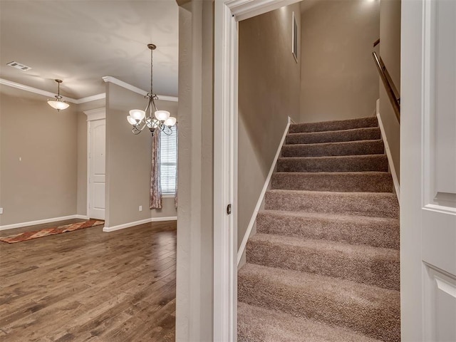 1832 Buckskin Ct, Blanchard, OK 73010 - stairway featuring wood finished floors, a chandelier, baseboards, ornamental molding, and visible vents