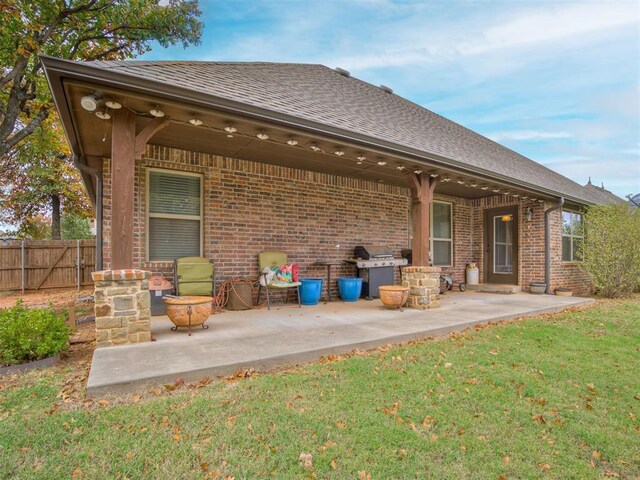 1832 Buckskin Ct, Blanchard, OK 73010 - rear view of house with a yard, brick siding, fence, and a patio area