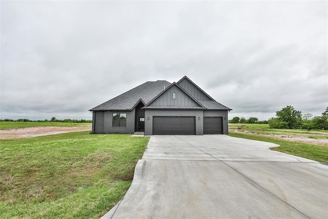 view of front of property featuring board and batten siding, a front yard, a garage, brick siding, and concrete driveway