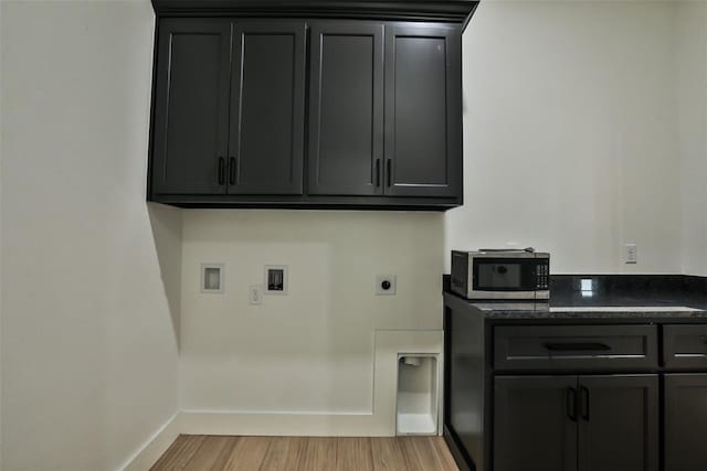 laundry area featuring electric dryer hookup, cabinet space, baseboards, light wood finished floors, and hookup for a washing machine