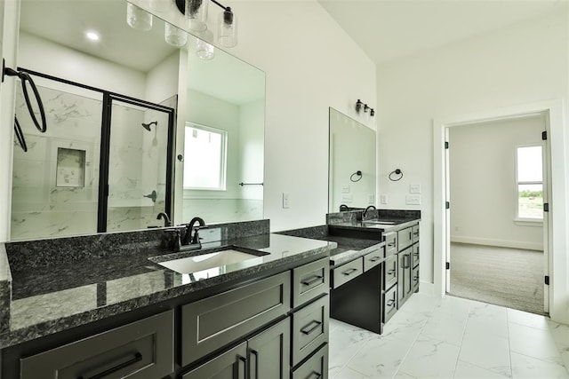 bathroom featuring a marble finish shower, baseboards, vanity, and marble finish floor