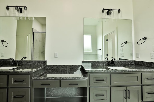 full bath featuring a sink and two vanities