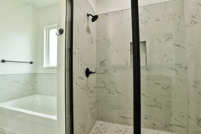 bathroom featuring a garden tub and a stall shower