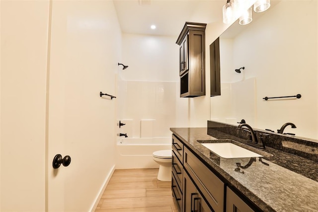full bathroom with vanity, shower / bathing tub combination, toilet, and wood finished floors