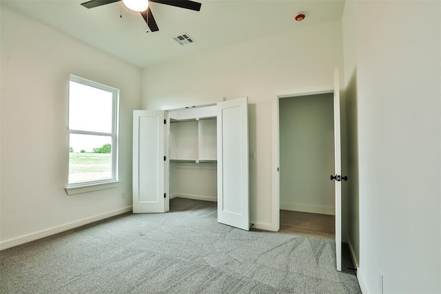 unfurnished bedroom with carpet, a ceiling fan, baseboards, visible vents, and a closet