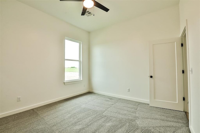 unfurnished room with baseboards, ceiling fan, carpet, and visible vents