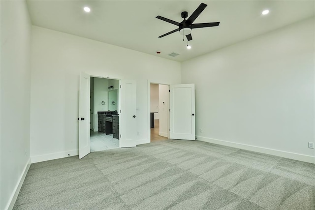 unfurnished bedroom with baseboards, recessed lighting, carpet, and ensuite bathroom