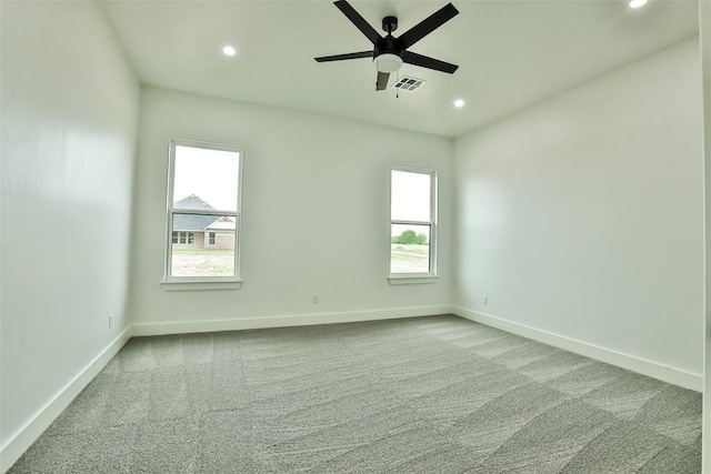 carpeted spare room with recessed lighting, baseboards, ceiling fan, and visible vents