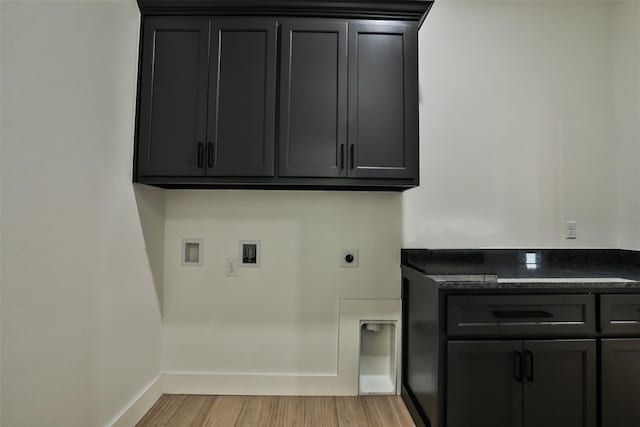 24694 Norte Rd, Purcell, OK 73080 - clothes washing area featuring baseboards, light wood-type flooring, cabinet space, electric dryer hookup, and washer hookup