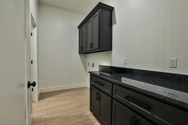 24694 Norte Rd, Purcell, OK 73080 - interior space with baseboards, hookup for an electric dryer, light wood-type flooring, and cabinet space