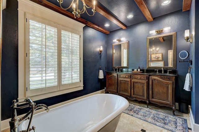 bathroom featuring a healthy amount of sunlight, a freestanding tub, a textured wall, and beamed ceiling