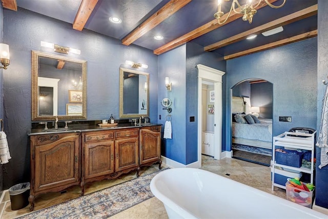 full bath featuring a sink, ensuite bath, beam ceiling, and a freestanding bath