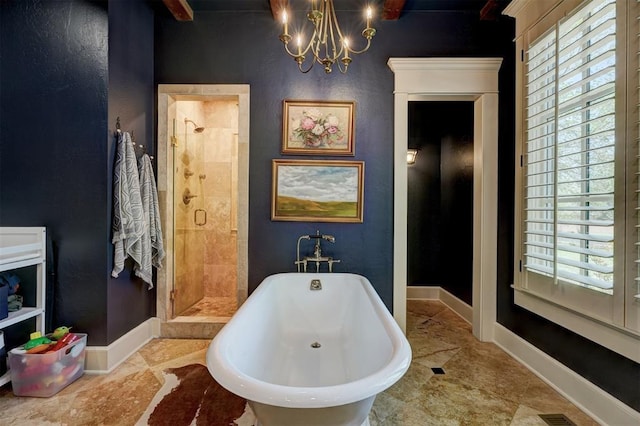 bathroom with plenty of natural light, baseboards, a freestanding bath, and a shower stall