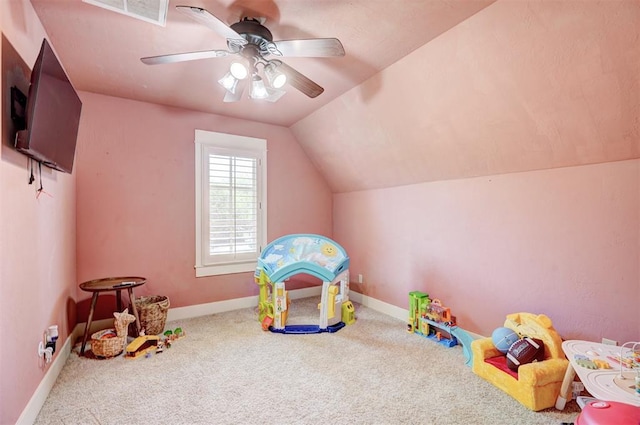 playroom with ceiling fan, visible vents, baseboards, lofted ceiling, and carpet flooring