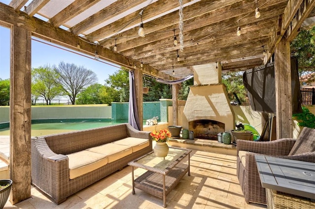 view of patio with fence and an outdoor living space with a fireplace