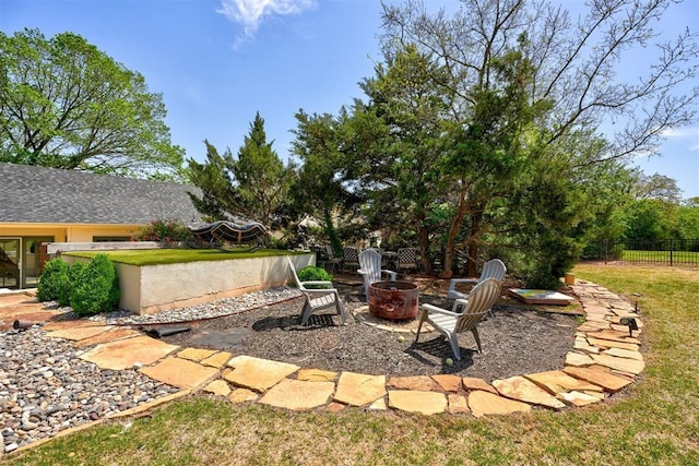 view of yard featuring fence and a fire pit