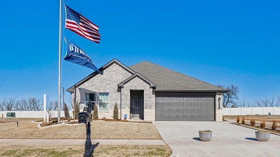 8417 NW 61st St, Oklahoma City, OK 73132 - view of front facade with concrete driveway and a garage