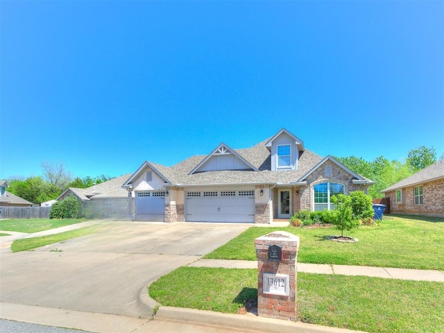 13612 Calabria Trl, Oklahoma City, OK 73170 - view of front facade with fence, a front lawn, driveway, stone siding, and a garage