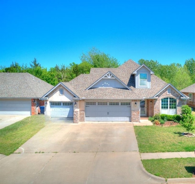 13612 Calabria Trl, Oklahoma City, OK 73170 - craftsman-style house featuring a front lawn, driveway, stone siding, and a garage