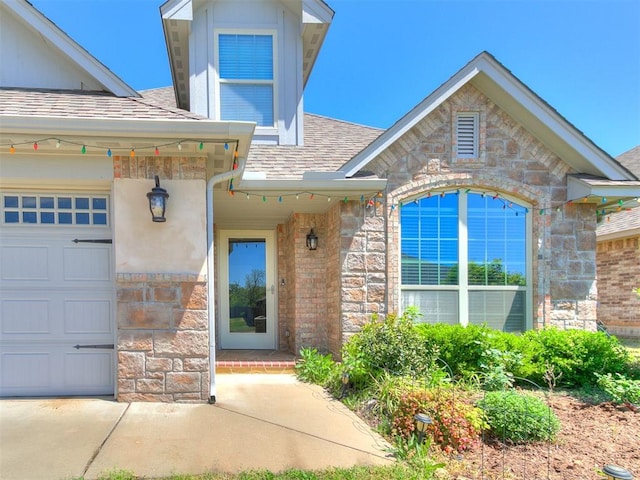 13612 Calabria Trl, Oklahoma City, OK 73170 - property entrance with stone siding, a shingled roof, and a garage