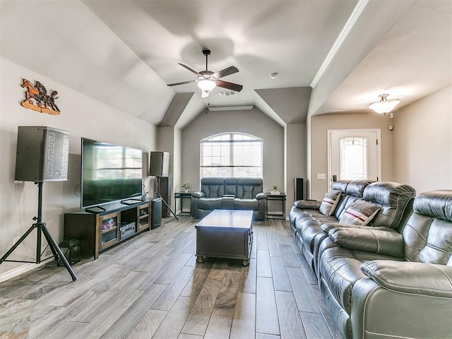 13612 Calabria Trl, Oklahoma City, OK 73170 - living area featuring ceiling fan, vaulted ceiling, a healthy amount of sunlight, and light wood-style flooring