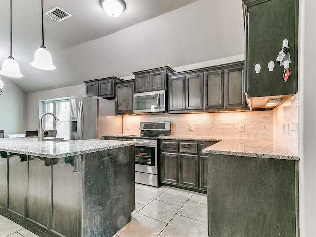 13612 Calabria Trl, Oklahoma City, OK 73170 - kitchen with visible vents, appliances with stainless steel finishes, light tile patterned floors, and a sink