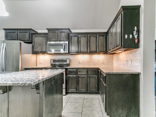 13612 Calabria Trl, Oklahoma City, OK 73170 - kitchen featuring backsplash, light stone countertops, stainless steel appliances, and light tile patterned floors