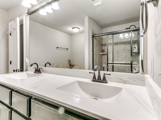 13612 Calabria Trl, Oklahoma City, OK 73170 - full bath with double vanity, a sink, visible vents, and a stall shower